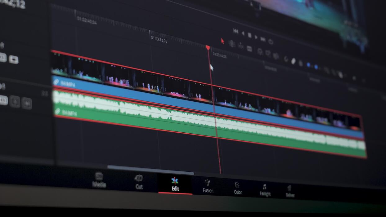 Video editing timeline showing a separate audio-description track placed around dialogue and important sound effects